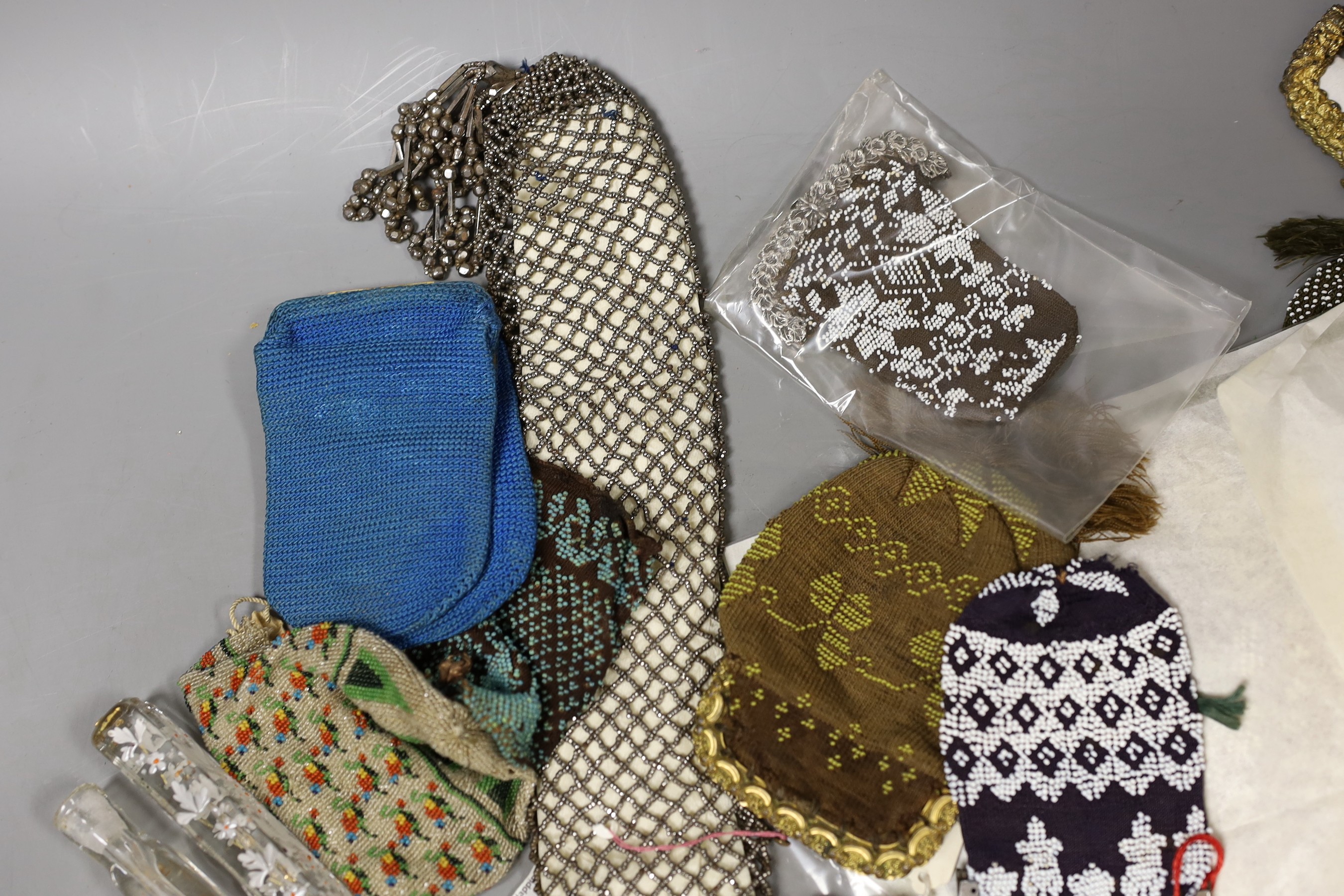 A group of mixed 19th century beadwork, cut steel and knitted purses, misers purses and reticules, together with two glass scent bottles and possibly the base to a walking stick covered with Berlin beadwork dated1832, wi